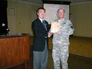 Richard Besselman (l), chapter president, presents a plaque of appreciation to Col. Joe Puett, USA, commander of the Joint Interoperability Test Command, for his speech at the September meeting.